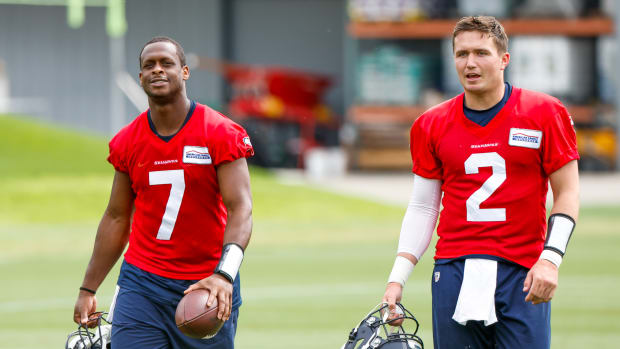 Seattle Seahawks quarterback Geno Smith (7) and quarterback Drew Lock (2) return to the locker room following minicamp practice at the Virginia Mason Athletic Center Field.